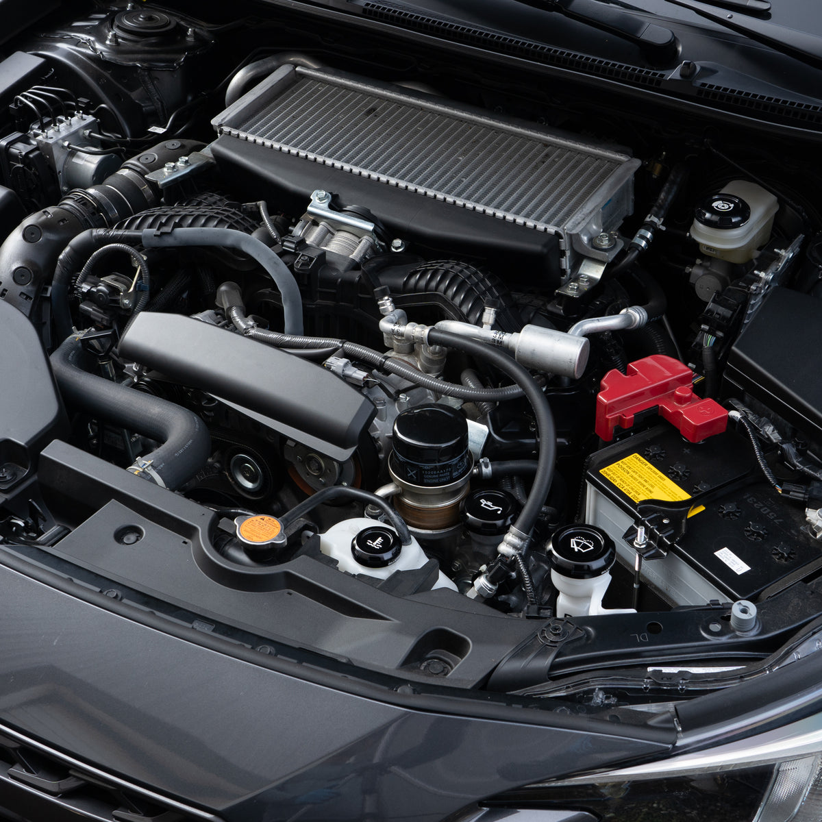 Billetworkz engine bay caps installed in a Subaru