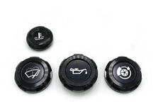 A set of four black anodized aluminum engine bay caps with engravings, including oil cap, wiper fluid cap, coolant overflow cap, and brake fluid cap symbols.