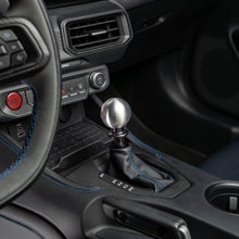 Close-up of a car's gear shift lever and surrounding interior.