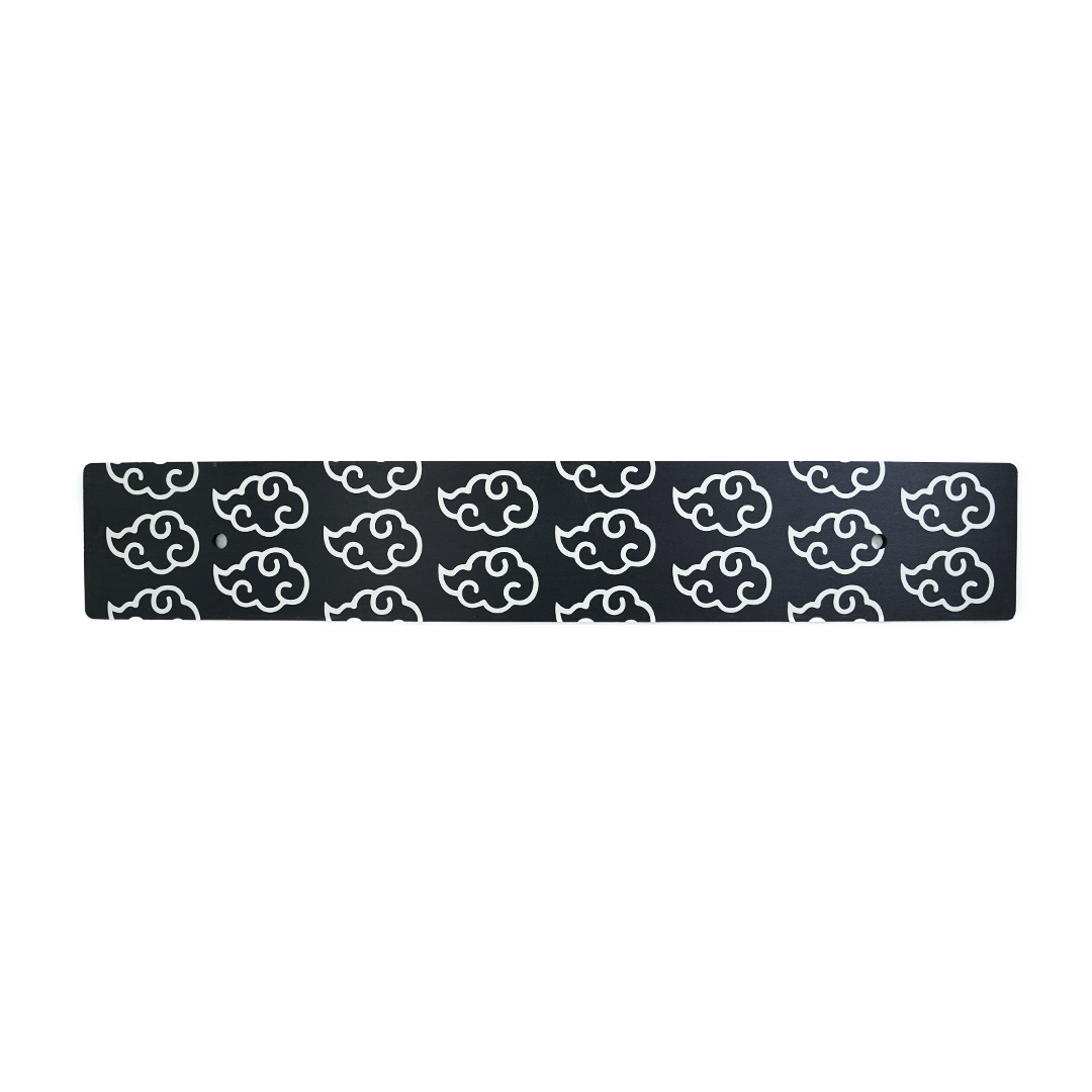 A black anodized aluminum license plate delete with white cloud patterns
