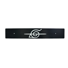 A black anodized aluminum license plate delete with a white Naruto symbol in the center.