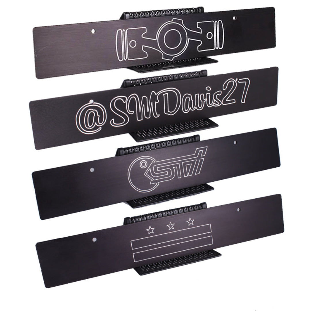 Set of black metal nameplates with white text and branding on a white background