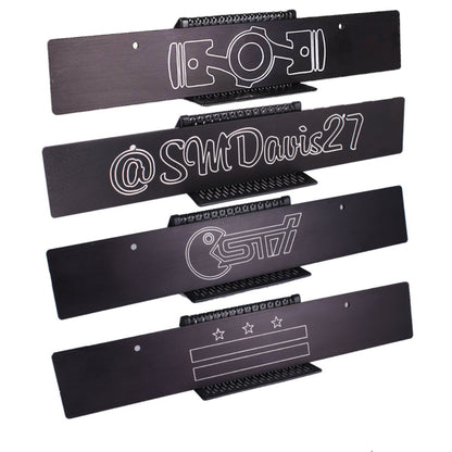 Set of black metal nameplates with white text and branding on a white background