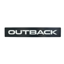 Black anodized license plate with the brand 'Outback' milled into the surface.