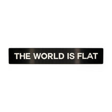 A black license plate delete with the phrase 'THE WORLD IS FLAT' in white text.