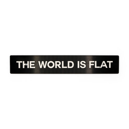 A black license plate delete with the phrase 'THE WORLD IS FLAT' in white text.