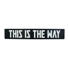 A black anodized aluminum license plate delete with white text 'THIS IS THE WAY' on it.