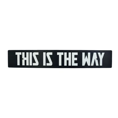A black anodized aluminum license plate delete with white text 'THIS IS THE WAY' on it.