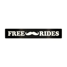 A black anodized aluminum license plate delete with white text and a mustache symbol, reading 'FREE Mustache Rides'.
