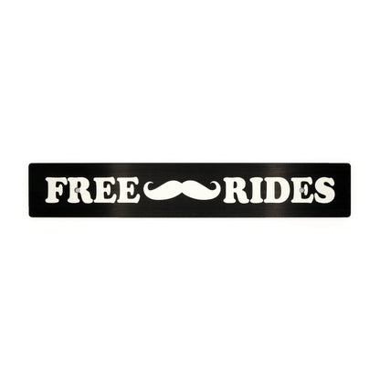 A black anodized aluminum license plate delete with white text and a mustache symbol, reading 'FREE Mustache Rides'.