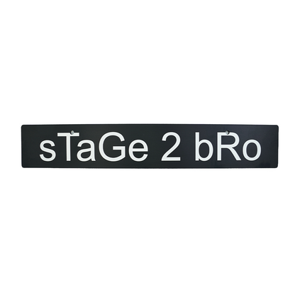 A black front license plate delete with the text 'sTaGe 2 bRo' in white.