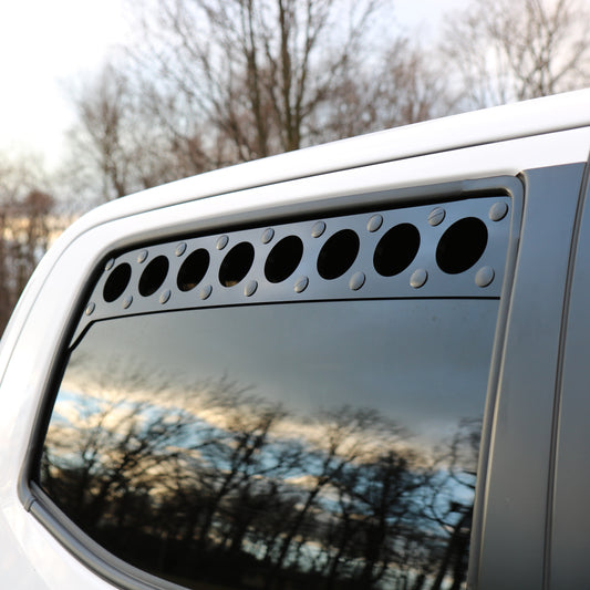  installed billetworkz window vents on a toyota tacoma vehicle, featuring a row of circular vents on the window.